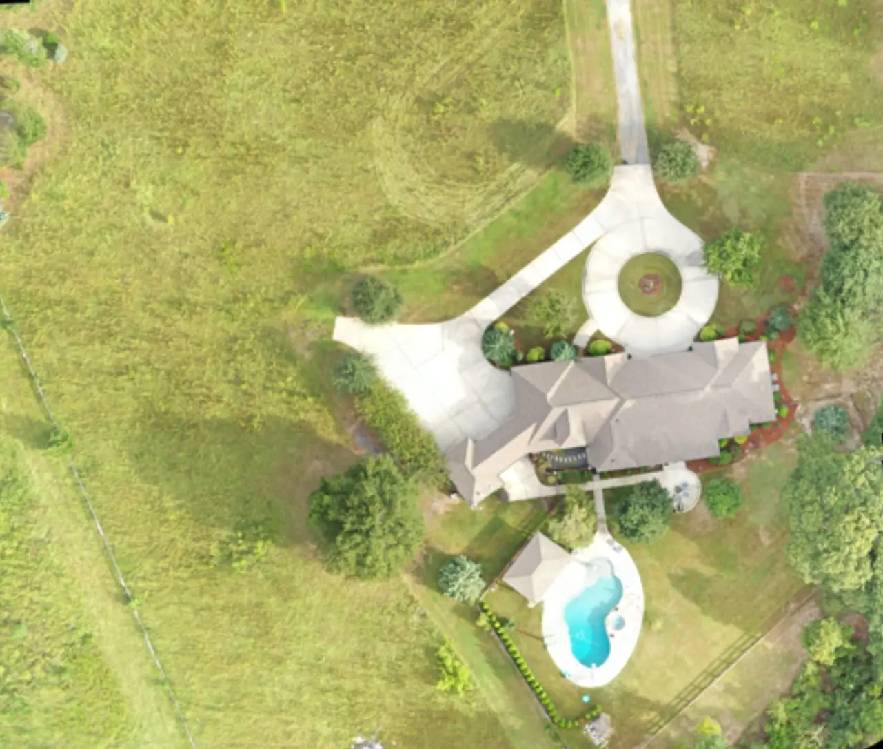Orthomosaic map of a residence with circular driveway and pool
